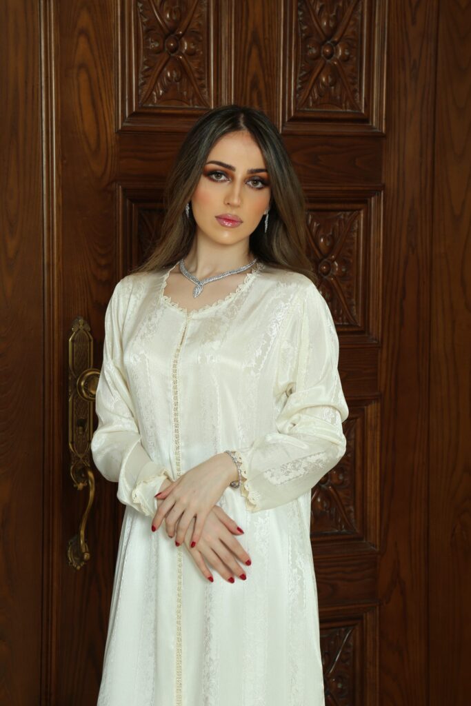 Elegant Handcrafted Randa Dress, made from premium Silk Jawhara Randa, featuring intricate hand-stitched embroidery. Includes a matching belt for a refined silhouette. Ideal for formal occasions, weddings, and cultural celebrations.