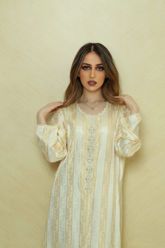 Elegant Handcrafted Randa Kaftan, made from authentic Silk Jawhara Randa, featuring intricate hand-sewn embroidery. Includes a matching belt for a tailored fit. Perfect for formal occasions, weddings, and cultural events.